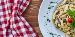 Travel-friendly healthy snacks like trail mix, protein bar, fruit, and nuts for eating healthy while traveling